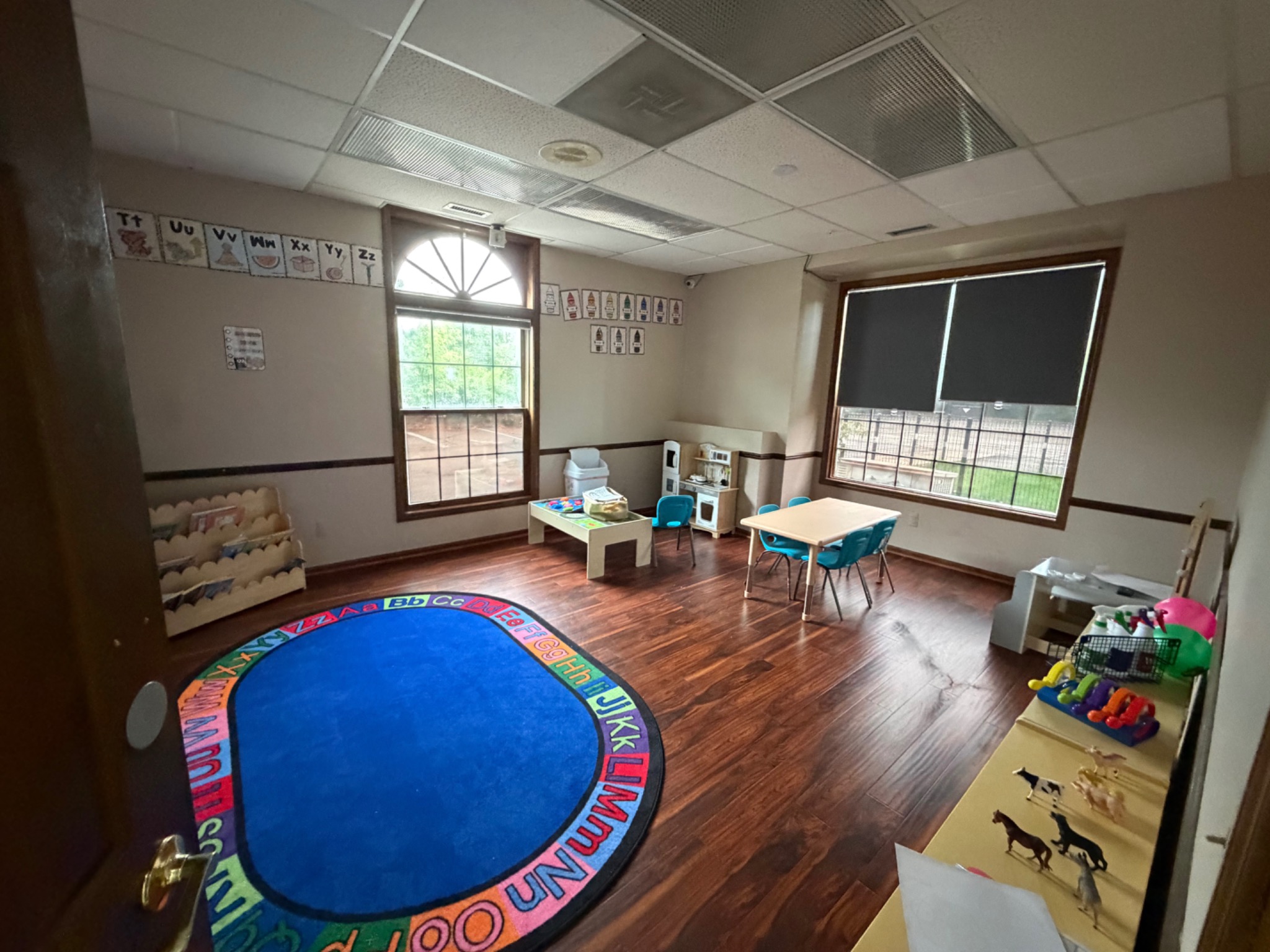 Sunny classroom with tables and play centers