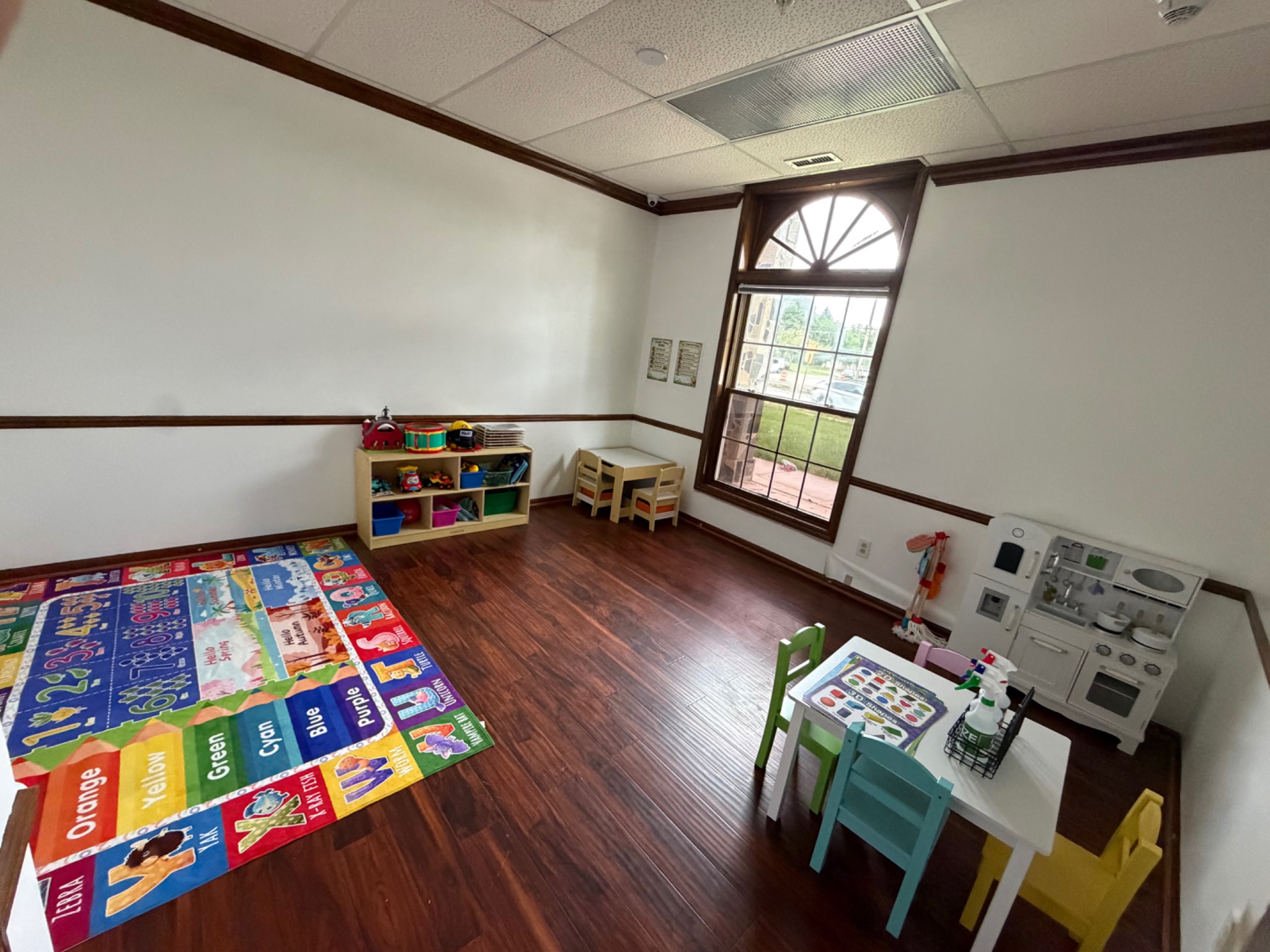 Classroom with colorful learning rug and activity centers